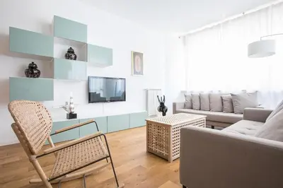 a living room with a couch and a tv at My Trastevere Three Bedroom View Apartment in Rome