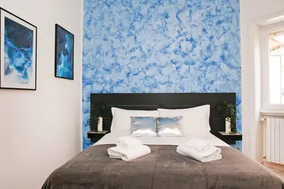 a bedroom with a bed with two towels on it at Charming Patio Apartment Trastevere in Rome