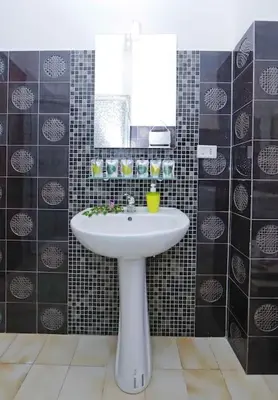 a bathroom with a white sink and a mirror at Charming Patio Apartment Trastevere in Rome