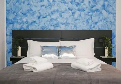 a bedroom with a large bed with two towels on it at Charming Patio Apartment Trastevere in Rome