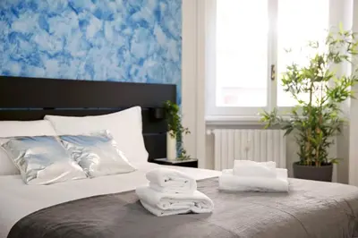 a bed with two towels sitting on top of it at Charming Patio Apartment Trastevere in Rome