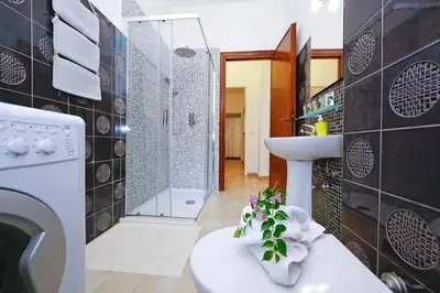 a bathroom with a toilet and a sink and a shower at Charming Patio Apartment Trastevere in Rome
