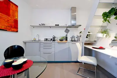 a small kitchen with a glass table and chairs at Terrace Modern Studio Trastevere in Rome