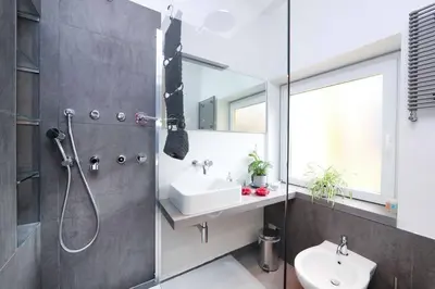 a bathroom with a shower and a sink and a mirror at Terrace Modern Studio Trastevere in Rome