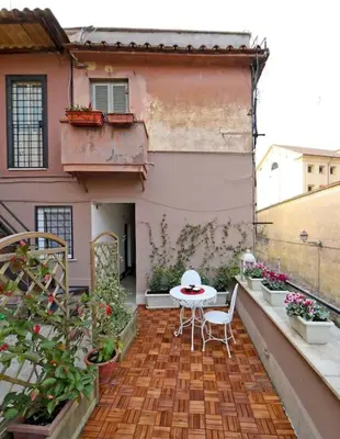 a balcony with a table and chairs on a building at Terrace Modern Studio Trastevere in Rome