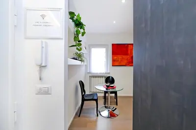 a dining room with a table and a chair at Terrace Modern Studio Trastevere in Rome