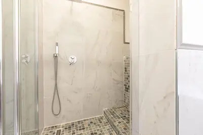 a shower with a glass door in a bathroom at Trastevere Silver King Jacuzzi Suite in Rome