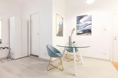 a dining room with a table and a blue chair at Trastevere Silver King Jacuzzi Suite in Rome