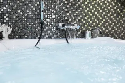 a bath tub filled with water with a faucet at Trastevere Silver King Jacuzzi Suite in Rome