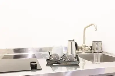 a kitchen counter top with a sink and a sink at Trastevere Silver King Jacuzzi Suite in Rome