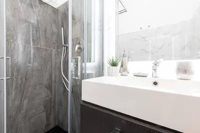 a bathroom with a sink and a shower at Romantic Jacuzzi Suite Trastevere in Rome