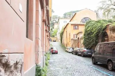 an alley with cars parked on the side of a building at Romantic Jacuzzi Suite Trastevere in Rome