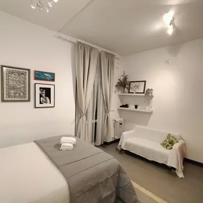 a bedroom with two beds and a window at Appartamento Musei Vaticani in Rome