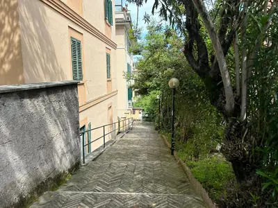 a stone walkway next to a building with a street light at Appartamento Musei Vaticani in Rome
