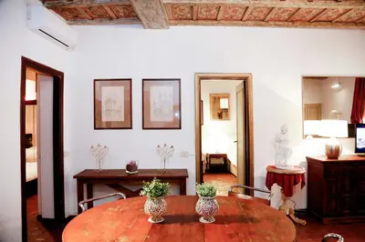 a room with a table with two vases on it at Decor Inspiration Apartment in Rome