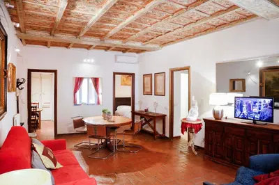 a living room with a red couch and a tv at Decor Inspiration Apartment in Rome