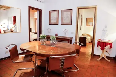 a dining room with a wooden table and chairs at Decor Inspiration Apartment in Rome