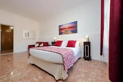 a bedroom with a large white bed with red pillows at YCH-Luminoso appartamento per 8 pax in Rome