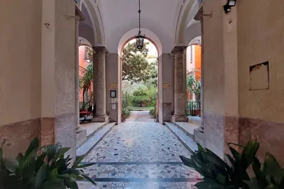 an empty hallway with plants in a building at YCH-Luminoso appartamento per 8 pax in Rome