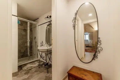 a bathroom with a sink and a mirror at GuestHost - Palazzo Altieri Elegant Apartment in Rome