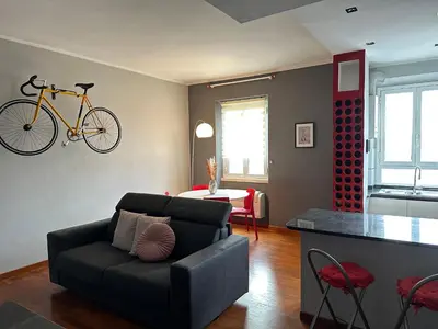 a living room with a couch and a bike on the wall at Window in the sky by Palazzo Senesi in Rome