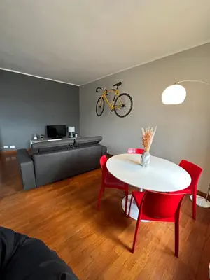 a living room with a table and a bike on the wall at Window in the sky by Palazzo Senesi in Rome