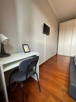 a room with a desk with a chair and a couch at Window in the sky by Palazzo Senesi in Rome