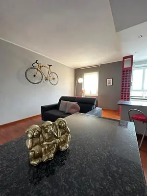 a living room with a table and a bike on the wall at Window in the sky by Palazzo Senesi in Rome