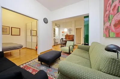 a living room with a couch and a bedroom at Laterano in Rome