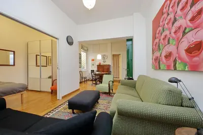 a living room with couches and a painting on the wall at Laterano in Rome