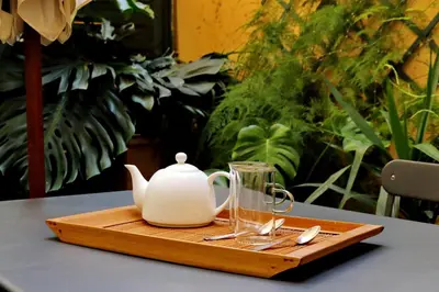 a wooden tray with a tea kettle and a glass at Laterano in Rome