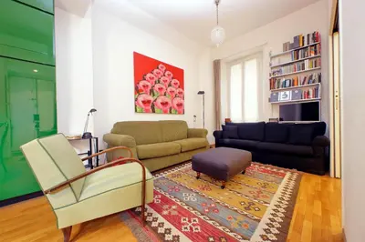 a living room with a couch and a chair at Laterano in Rome