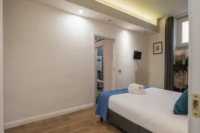 a bedroom with a bed and a window at La luna nel pozzo a Roma in Rome
