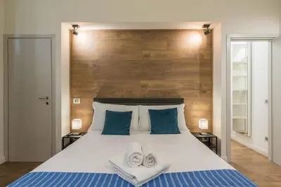 a bedroom with a large bed with towels on it at La luna nel pozzo a Roma in Rome