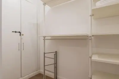 a walk in closet with a glass door and a ladder at La luna nel pozzo a Roma in Rome