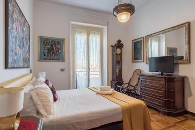 a bedroom with a bed with a television and a dresser at Charming Mazzini Apartment in Rome