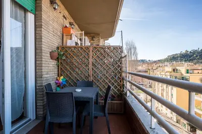 a balcony with a table and chairs on a balcony at Charming Mazzini Apartment in Rome