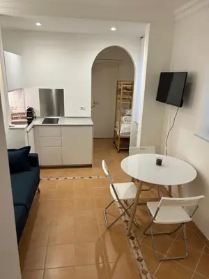 a living room with a table and a blue couch at Elle Cavour Apartment in Rome