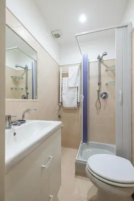 a bathroom with a toilet and a sink and a shower at Elle Cavour Apartment in Rome
