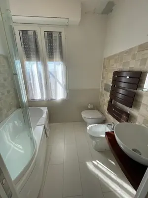a bathroom with a tub and a sink and a toilet at Terrace on the 11th floor in Rome