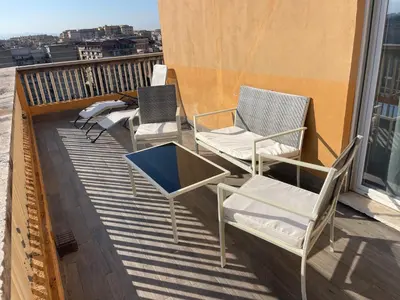 two chairs and a table on a balcony at Terrace on the 11th floor in Rome