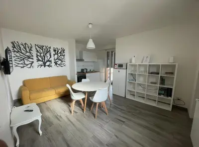 a living room with a couch and a table and chairs at Terrace on the 11th floor in Rome