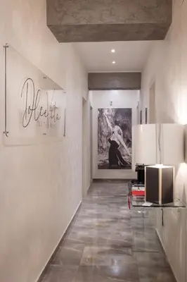 a kitchen with a refrigerator and a painting on the wall at DolceVitaSuite in Rome