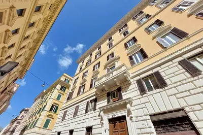 a building in the middle of two tall buildings at DolceVitaSuite in Rome