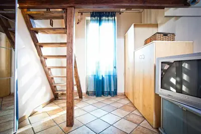 a living room with a staircase and a television at Laura's Brother - Close to St. John's Basilica in Rome