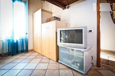 a television sitting on a stand in a room at Laura's Brother - Close to St. John's Basilica in Rome