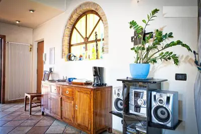 a living room with a wooden cabinet and a potted plant at Laura's Brother - Close to St. John's Basilica in Rome