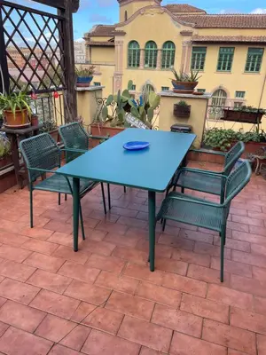 a blue table and chairs on a patio at Laura's Brother - Close to St. John's Basilica in Rome