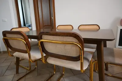 a dining room table with four chairs around it at Pantheon Boutique Apartment 