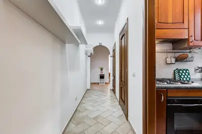 a kitchen with white walls and a tile floor at Pantheon Boutique Apartment 